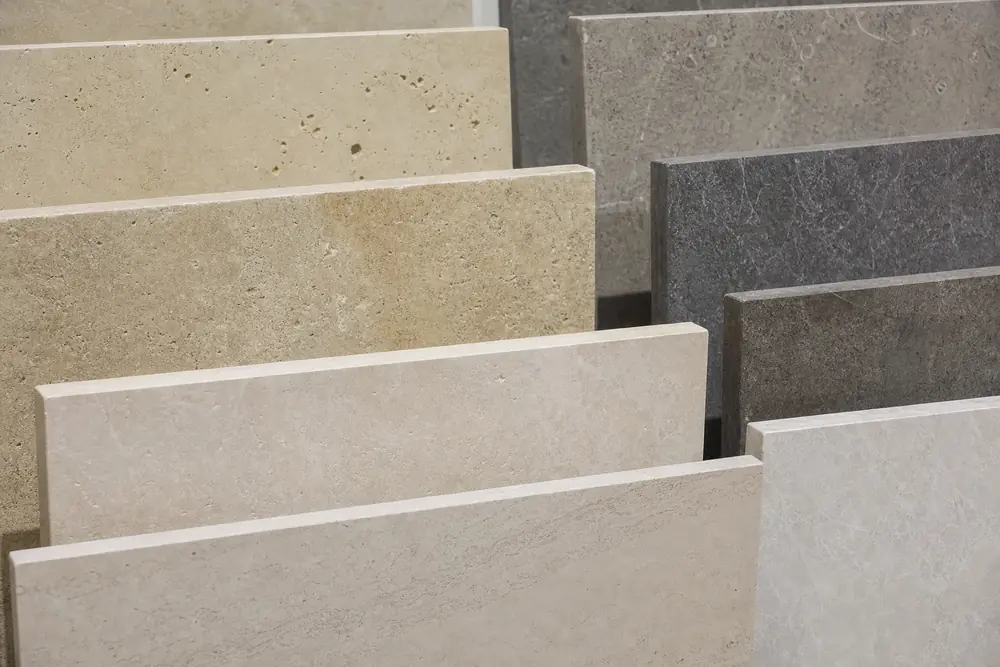 Natural stone and stone-look samples in warm neutral and grey tones